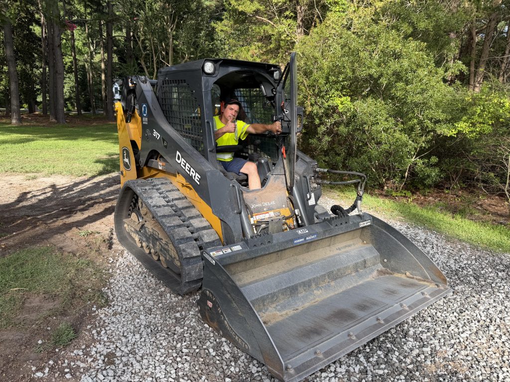 Skid steer loader operator working a gravel area on a Sturtz Contracting job site